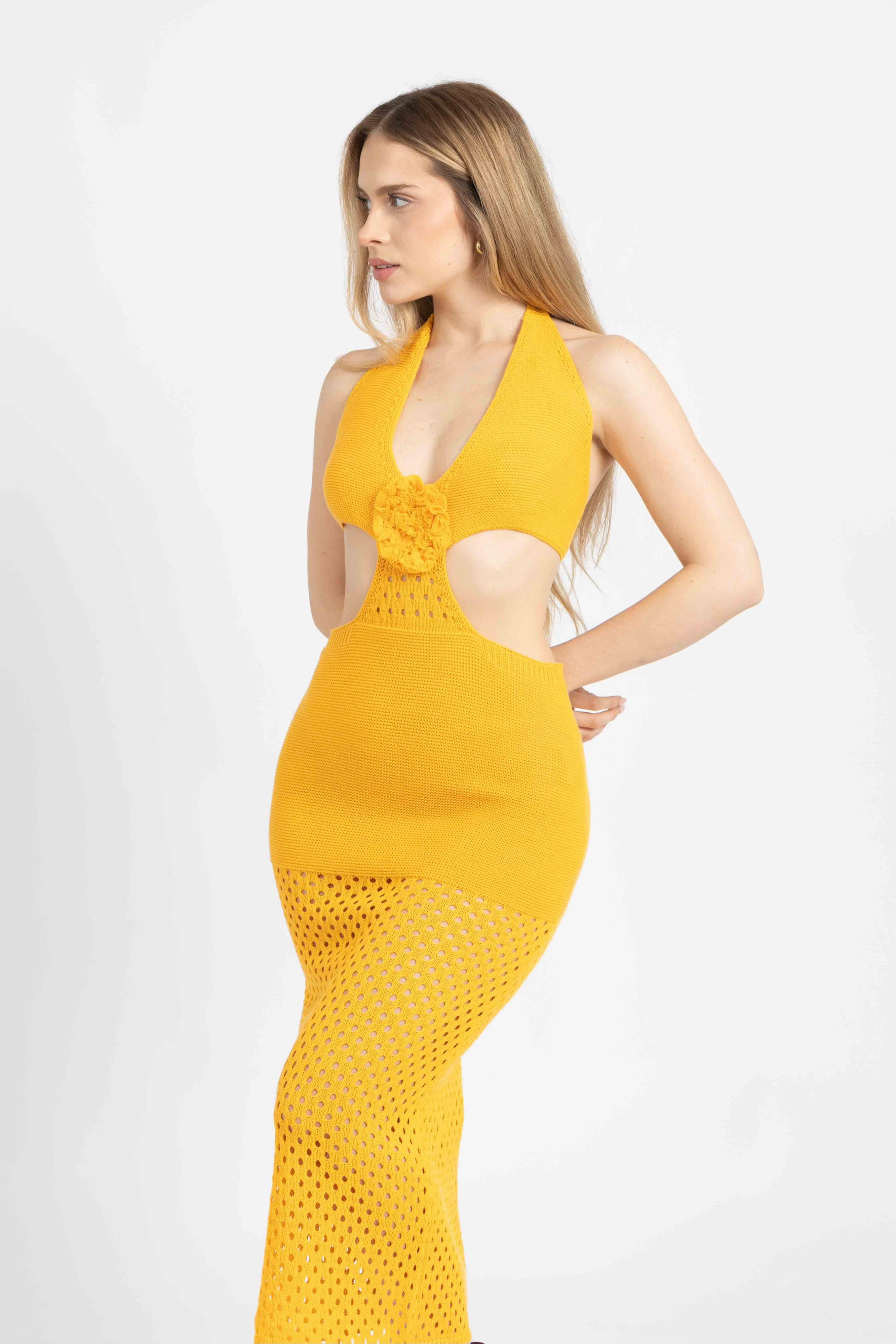 Model wearing Cleo crochet knit midi dress in yellow with side cut-outs and plunging neckline, photographed in studio – GYA